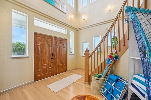 6543 Louise Ct, Hudson, FL 34667 - entryway with wood finished floors, stairway, and a towering ceiling