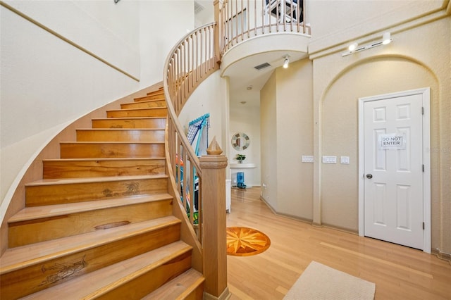 6543 Louise Ct, Hudson, FL 34667 - stairs with wood finished floors and a towering ceiling