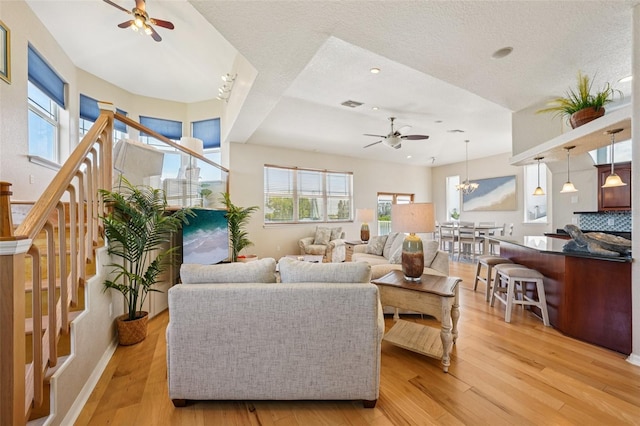 6543 Louise Ct, Hudson, FL 34667 - living area with a ceiling fan, light wood-type flooring, recessed lighting, a textured ceiling, and a chandelier