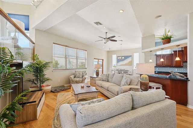 6543 Louise Ct, Hudson, FL 34667 - living room featuring a ceiling fan, a chandelier, a textured ceiling, light wood finished floors, and recessed lighting