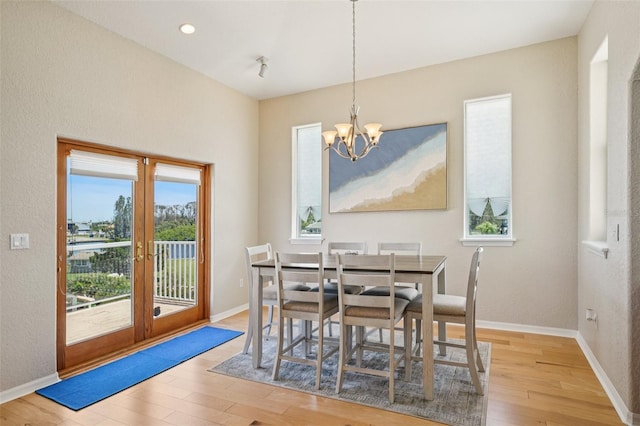 6543 Louise Ct, Hudson, FL 34667 - dining area with a chandelier, wood finished floors, french doors, and recessed lighting