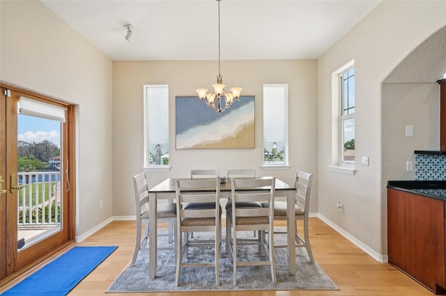 6543 Louise Ct, Hudson, FL 34667 - dining area featuring a chandelier and light wood-style flooring