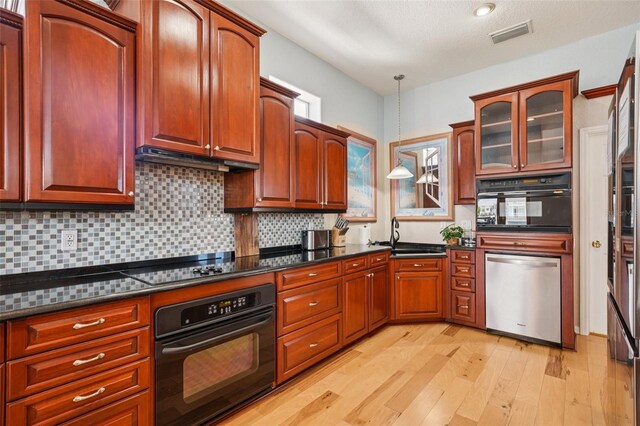 6543 Louise Ct, Hudson, FL 34667 - kitchen featuring black appliances, light wood-type flooring, pendant lighting, backsplash, and glass insert cabinets