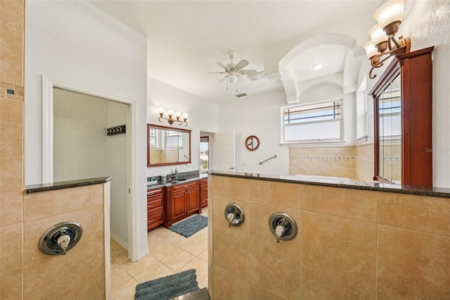 6543 Louise Ct, Hudson, FL 34667 - bathroom featuring tile patterned floors, a ceiling fan, vanity, and a relaxing tiled tub
