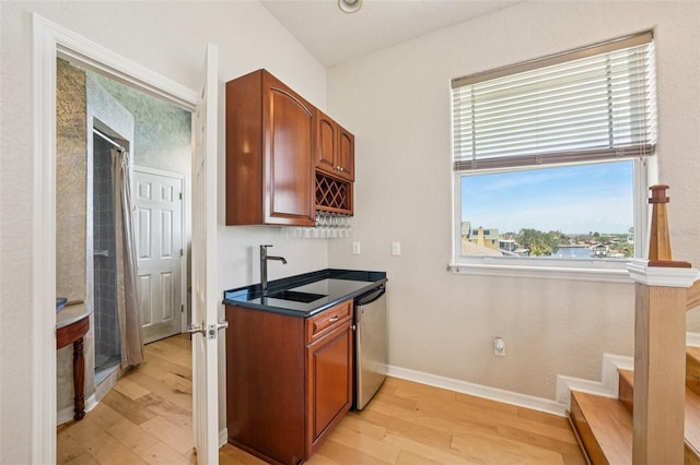 6543 Louise Ct, Hudson, FL 34667 - kitchen featuring light wood finished floors, dishwasher, dark countertops, and brown cabinetry