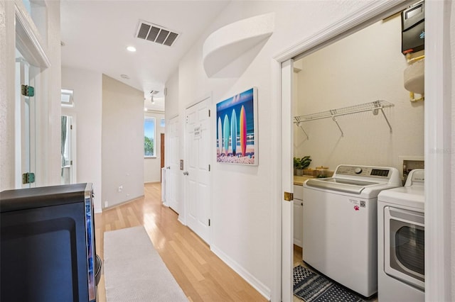 6543 Louise Ct, Hudson, FL 34667 - laundry room featuring washing machine and clothes dryer, light wood-type flooring, and recessed lighting