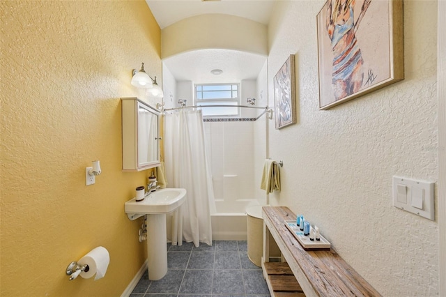 6543 Louise Ct, Hudson, FL 34667 - bathroom featuring a textured wall, shower / bath combination with curtain, and tile patterned flooring