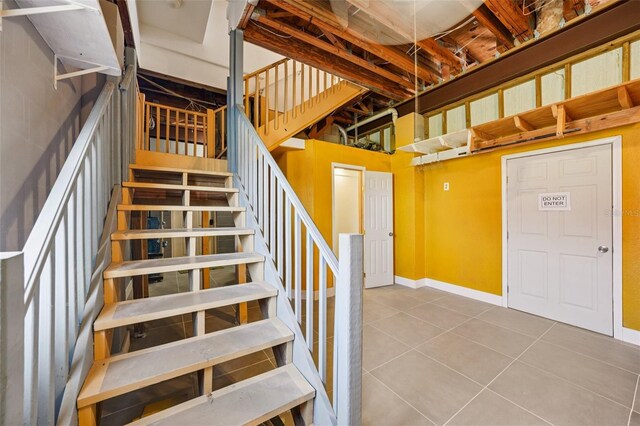 6543 Louise Ct, Hudson, FL 34667 - staircase with tile patterned floors and baseboards
