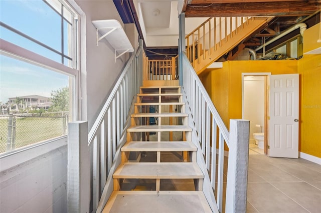 6543 Louise Ct, Hudson, FL 34667 - staircase featuring tile patterned flooring and a high ceiling