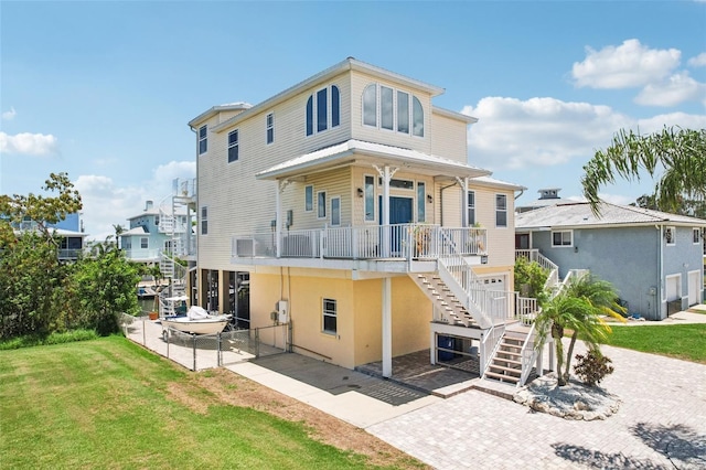 6543 Louise Ct, Hudson, FL 34667 - rear view of property featuring stairway and covered porch