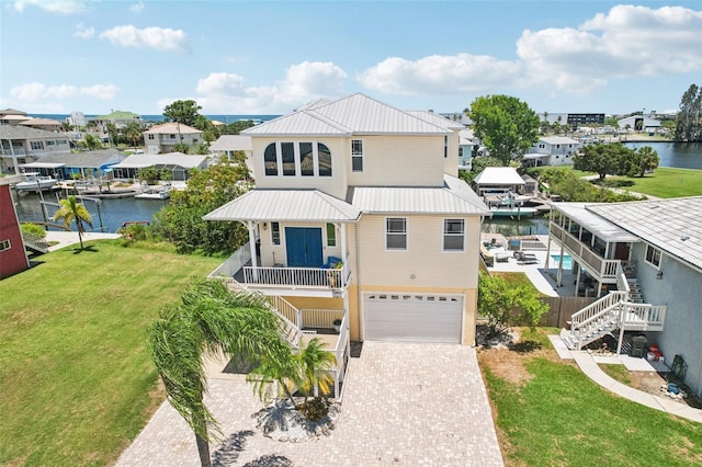 6543 Louise Ct, Hudson, FL 34667 - raised beach house with stairs, an attached garage, driveway, a water view, and a metal roof