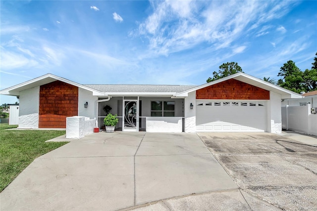 9619 Towanda Ln, Port Richey, FL 34668 - single story home featuring an attached garage, driveway, stucco siding, and roof with shingles