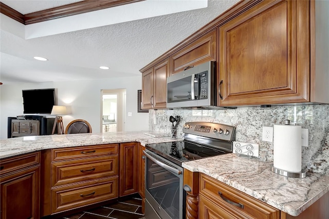 9619 Towanda Ln, Port Richey, FL 34668 - kitchen with appliances with stainless steel finishes, brown cabinetry, tasteful backsplash, recessed lighting, and a textured ceiling