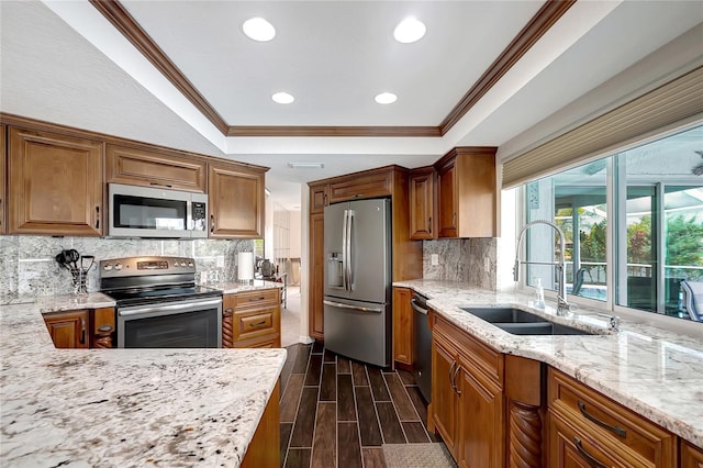 9619 Towanda Ln, Port Richey, FL 34668 - kitchen with stainless steel appliances, a tray ceiling, crown molding, light stone counters, and recessed lighting
