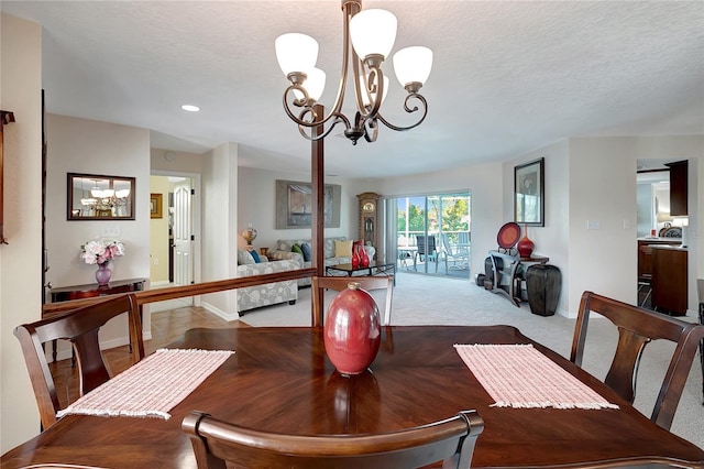 9619 Towanda Ln, Port Richey, FL 34668 - carpeted dining space with a chandelier, a textured ceiling, and recessed lighting