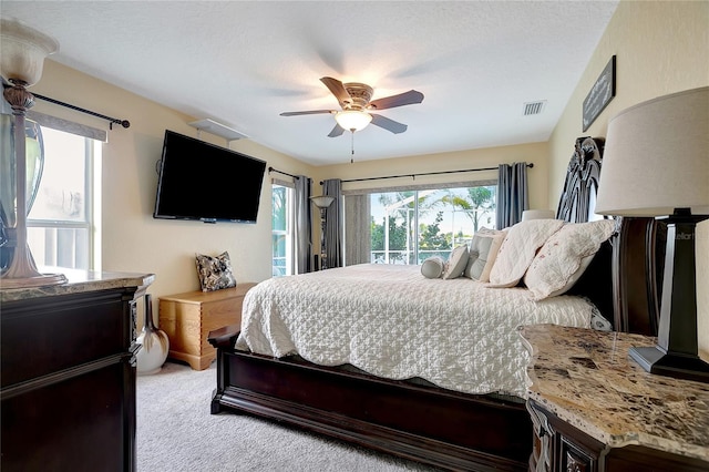 9619 Towanda Ln, Port Richey, FL 34668 - bedroom featuring access to exterior, light carpet, and a ceiling fan
