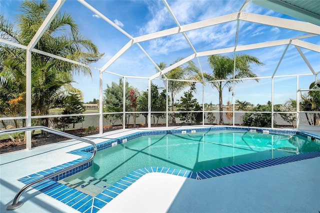 9619 Towanda Ln, Port Richey, FL 34668 - outdoor pool featuring glass enclosure and a patio area
