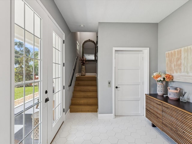 1340 Bayshore Blvd Unit 502, Dunedin, FL 34698 - entrance foyer featuring healthy amount of natural light, french doors, stairway, and tile patterned flooring