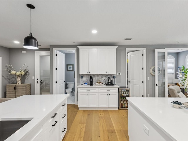 1340 Bayshore Blvd Unit 502, Dunedin, FL 34698 - kitchen featuring light countertops, recessed lighting, light wood-style floors, white cabinetry, and hanging light fixtures