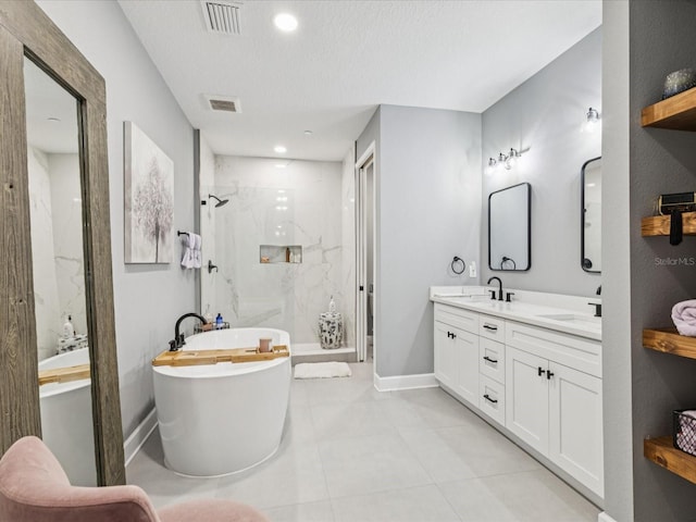 1340 Bayshore Blvd Unit 502, Dunedin, FL 34698 - full bath with a marble finish shower, a freestanding bath, double vanity, tile patterned floors, and recessed lighting