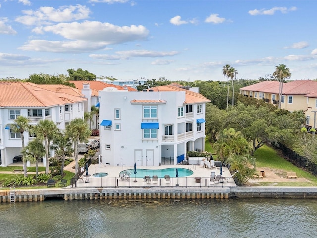 1340 Bayshore Blvd Unit 502, Dunedin, FL 34698 - rear view of property with a patio area, an outdoor pool, stucco siding, and a water view