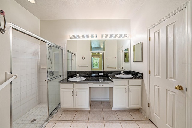 1914 Sassafras Dr, Wesley Chapel, FL 33543 - full bath with double vanity, a stall shower, tile patterned floors, and a ceiling fan