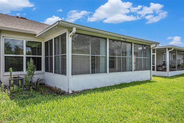 1914 Sassafras Dr, Wesley Chapel, FL 33543 - view of home's exterior featuring a sunroom and a yard