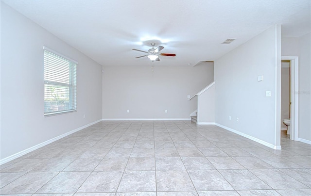 208 English Heritage Pl, Dover, FL 33527 - empty room featuring a ceiling fan, stairway, and light tile patterned floors