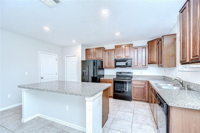 208 English Heritage Pl, Dover, FL 33527 - kitchen with black appliances, a center island, light tile patterned floors, recessed lighting, and brown cabinets