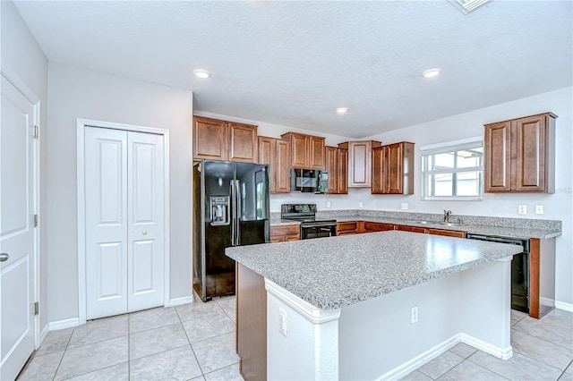 208 English Heritage Pl, Dover, FL 33527 - kitchen featuring black appliances, a center island, light countertops, brown cabinets, and recessed lighting