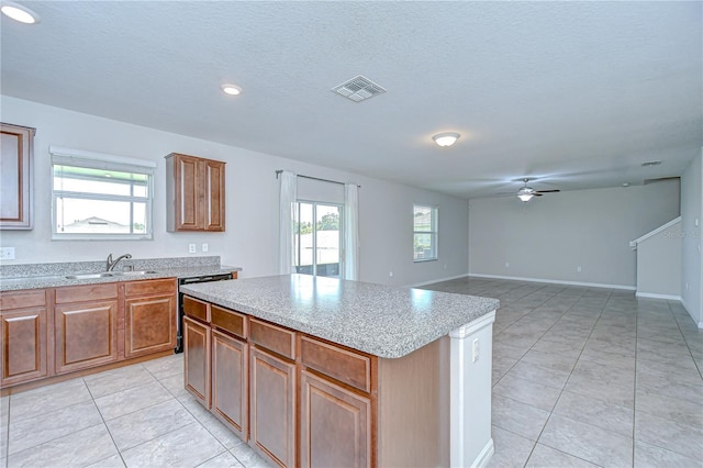 208 English Heritage Pl, Dover, FL 33527 - kitchen featuring dishwasher, a center island, a ceiling fan, light tile patterned floors, and brown cabinets