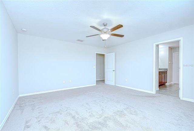 208 English Heritage Pl, Dover, FL 33527 - unfurnished bedroom featuring light colored carpet, ensuite bathroom, and ceiling fan