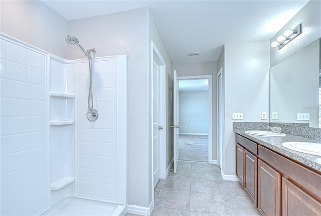 208 English Heritage Pl, Dover, FL 33527 - bathroom with a shower, double vanity, tile patterned flooring, and a textured ceiling