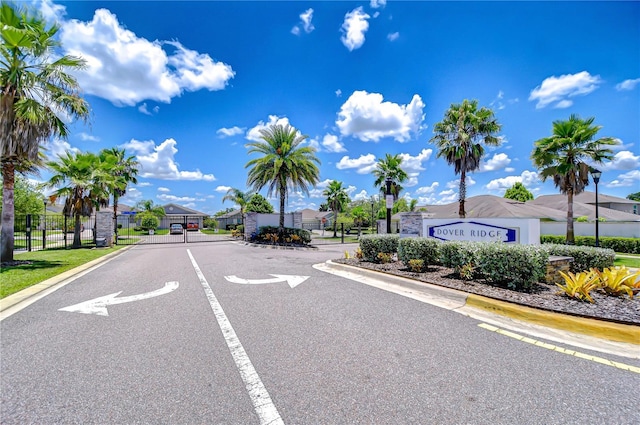 208 English Heritage Pl, Dover, FL 33527 - view of asphalt street with curbs, a gated entry, and a residential view