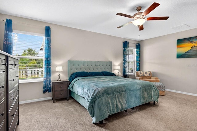 12835 Wildflower Meadow Dr, Riverview, FL 33579 - bedroom featuring light colored carpet, multiple windows, and a ceiling fan