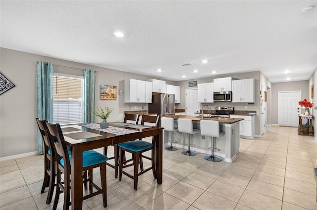 12835 Wildflower Meadow Dr, Riverview, FL 33579 - dining room featuring recessed lighting, light tile patterned flooring, and a textured ceiling