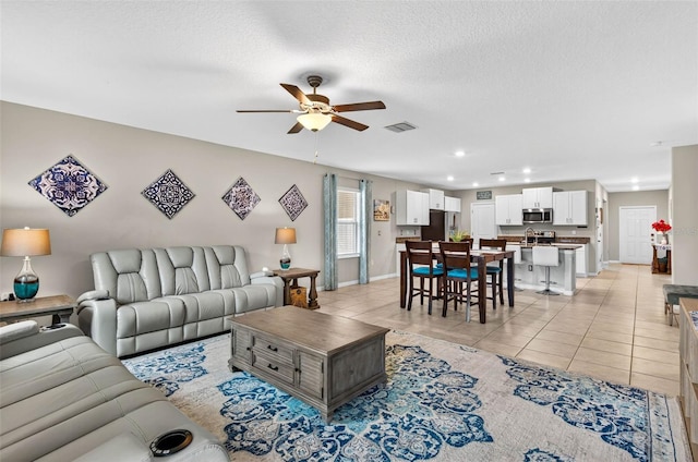 12835 Wildflower Meadow Dr, Riverview, FL 33579 - living room with a ceiling fan, light tile patterned floors, recessed lighting, and a textured ceiling
