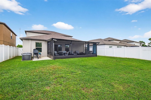 12835 Wildflower Meadow Dr, Riverview, FL 33579 - back of property featuring a sunroom, a fenced backyard, stucco siding, a patio area, and a shingled roof