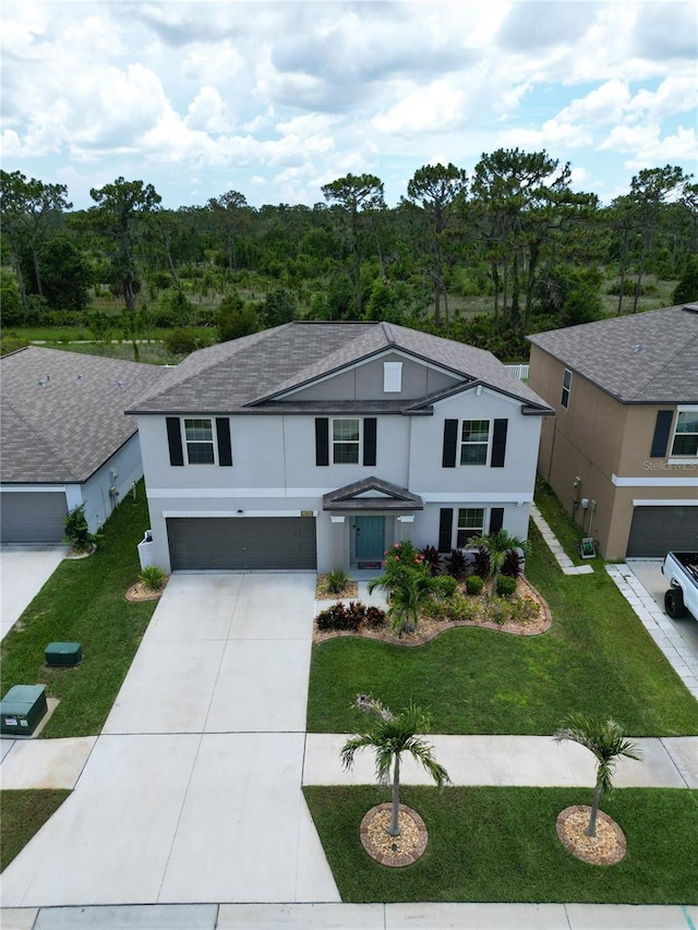 12835 Wildflower Meadow Dr, Riverview, FL 33579 - traditional home featuring an attached garage, driveway, stucco siding, and a front yard