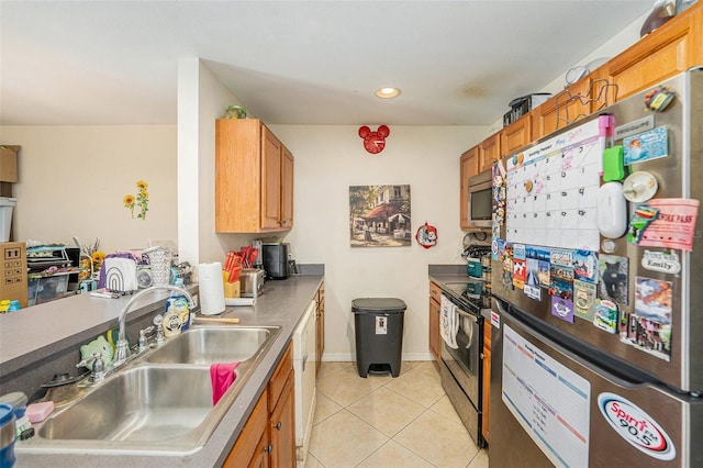 5501 67th Ave N Unit 11, Pinellas Park, FL 33781 - kitchen featuring appliances with stainless steel finishes, light tile patterned flooring, recessed lighting, and brown cabinetry