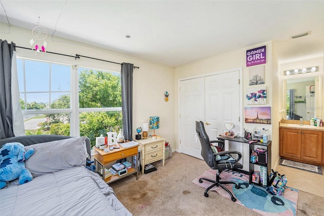 5501 67th Ave N Unit 11, Pinellas Park, FL 33781 - carpeted bedroom with a desk, a closet, and connected bathroom
