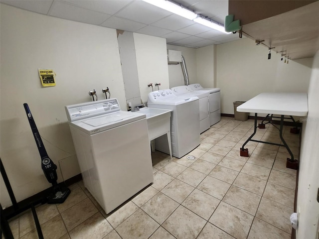400 64th Ave Unit 1105, St Pete Beach, FL 33706 - washroom with independent washer and dryer and light tile patterned flooring