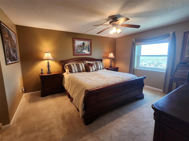 400 64th Ave Unit 1105, St Pete Beach, FL 33706 - bedroom with light carpet, a textured ceiling, and ceiling fan