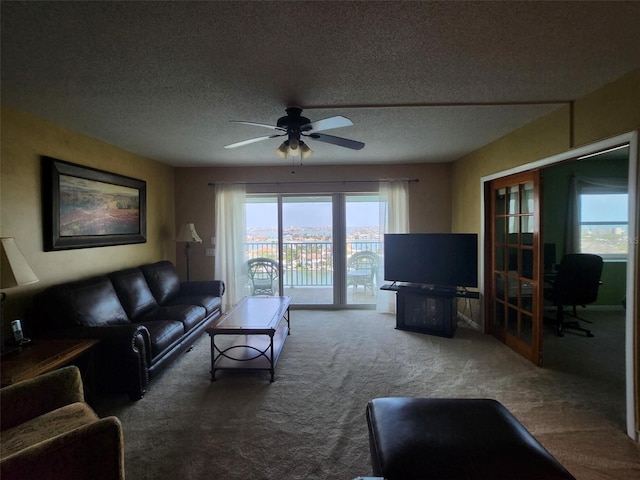 400 64th Ave Unit 1105, St Pete Beach, FL 33706 - carpeted living area featuring healthy amount of natural light, a textured ceiling, and ceiling fan