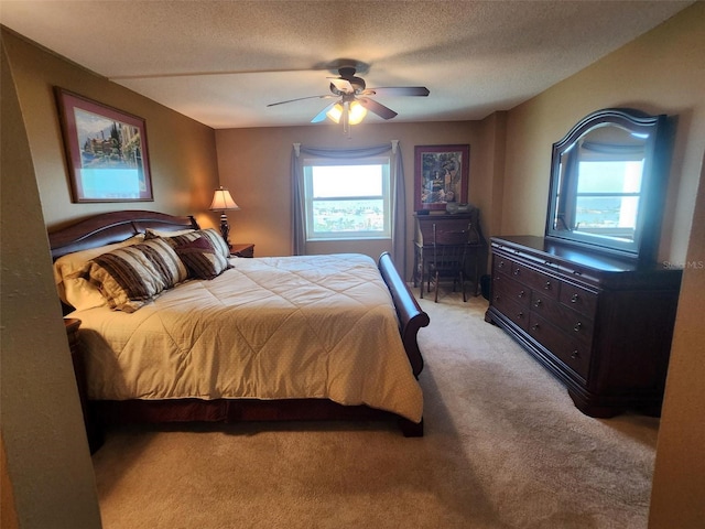 400 64th Ave Unit 1105, St Pete Beach, FL 33706 - bedroom featuring light carpet, a textured ceiling, and a ceiling fan