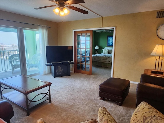 400 64th Ave Unit 1105, St Pete Beach, FL 33706 - carpeted living area featuring a ceiling fan, healthy amount of natural light, and a textured ceiling