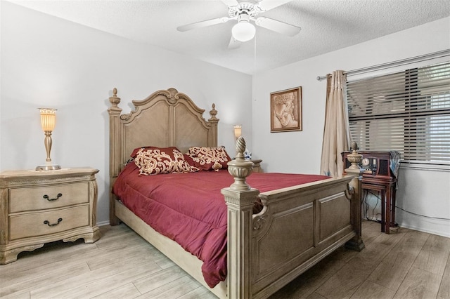 2922 60th St W, Bradenton, FL 34209 - bedroom featuring light wood-style flooring, a textured ceiling, and a ceiling fan