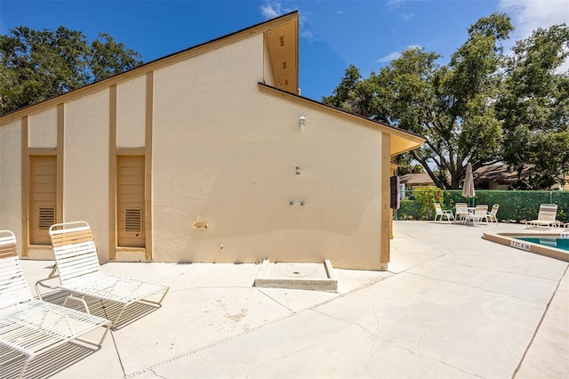 2922 60th St W, Bradenton, FL 34209 - back of house featuring a patio area, stucco siding, and a community pool