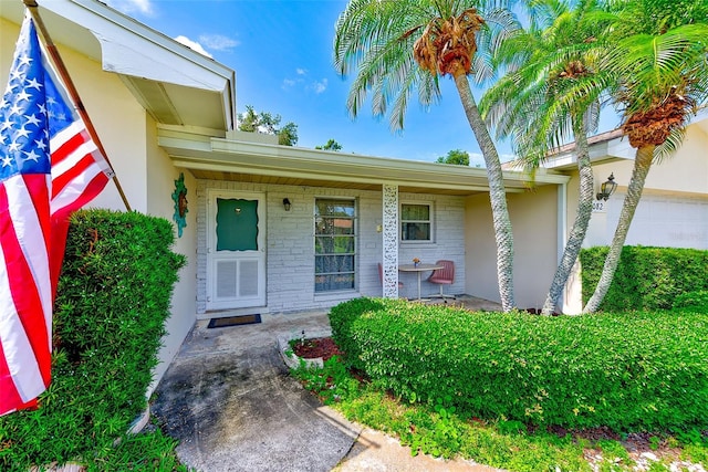 11082 90th Ter, Seminole, FL 33772 - entrance to property featuring stucco siding and a porch