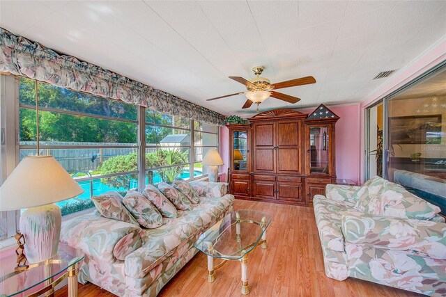 11082 90th Ter, Seminole, FL 33772 - living room with a ceiling fan and light wood-style flooring